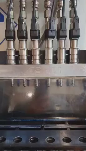 A set of 6 Siemens Piezo injectors being tested on an Asnu machine. Injector 3 is leaking profusely when under pressure.